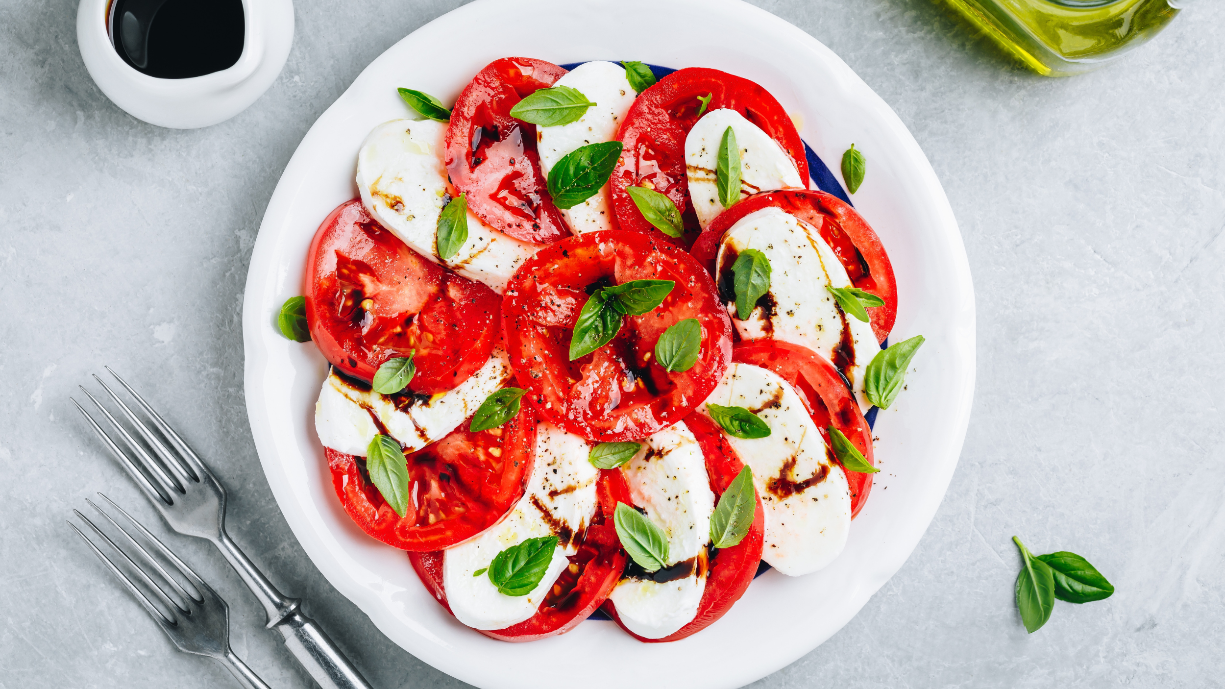 Health lunch view with tomatoes, oil and cheese.